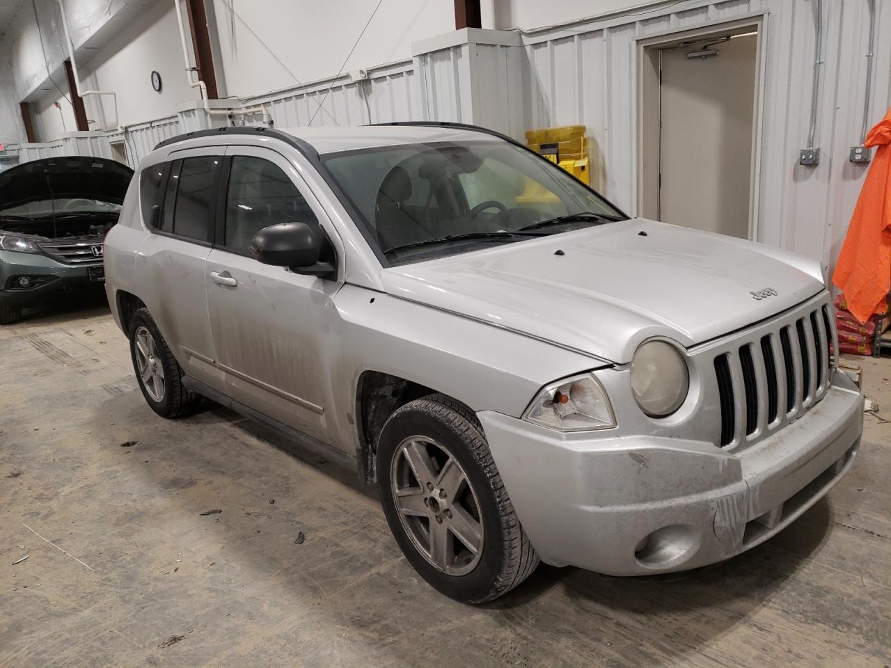 JEEP COMPASS SP 2010 with VIN 1J4NT4FB0AD521608 - Photo from auction