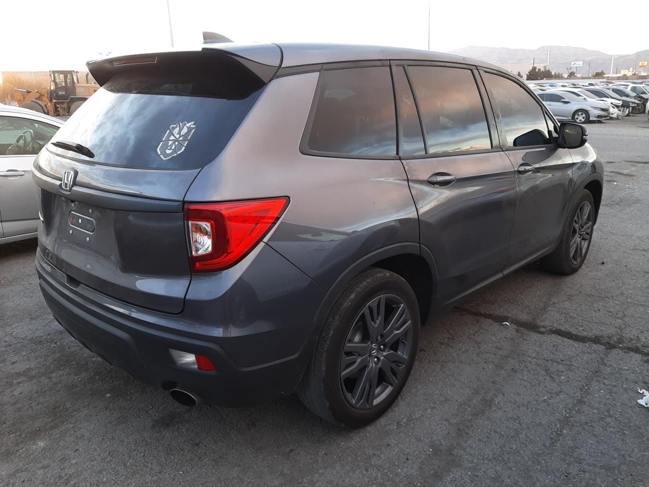 Photo 4 from auction – 2021 HONDA PASSPORT E with VIN 5FNYF7H5XMB001965