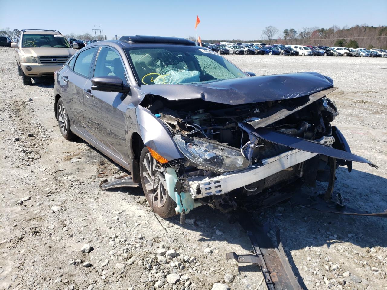 HONDA CIVIC EX 2018 with VIN 19XFC2F71JE019568 - Photo from auction