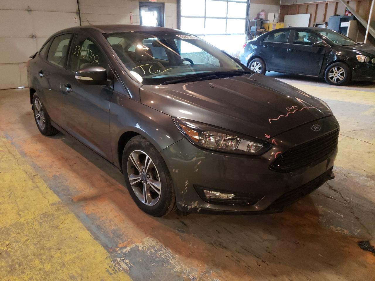 FORD FOCUS SE 2017 with VIN 1FADP3FEXHL310240 - Photo from auction