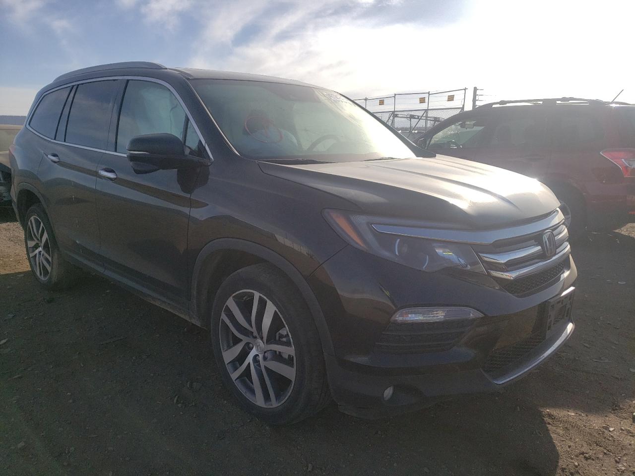 HONDA PILOT TOUR 2018 with VIN 5FNYF6H97JB052994 - Photo from auction
