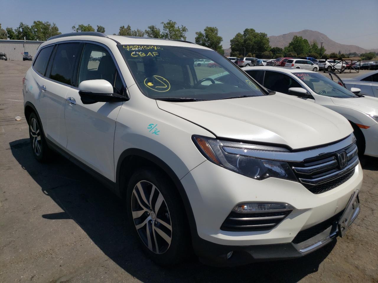 HONDA PILOT TOUR 2016 with VIN 5FNYF5H98GB028769 - Photo from auction