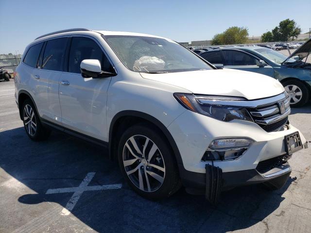 HONDA PILOT TOUR 2018 with VIN 5FNYF5H96JB015509 - Photo from auction