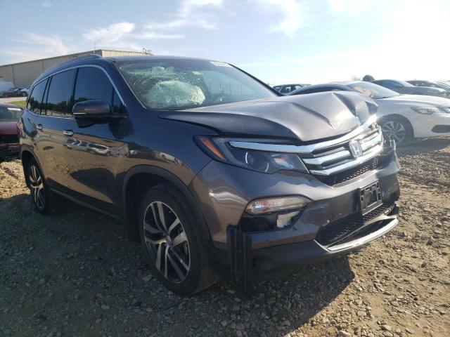 HONDA PILOT TOUR 2017 with VIN 5FNYF5H90HB013832 - Photo from auction