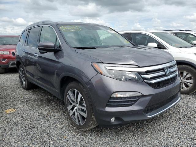 HONDA PILOT TOUR 2018 with VIN 5FNYF5H99JB010272 - Photo from auction