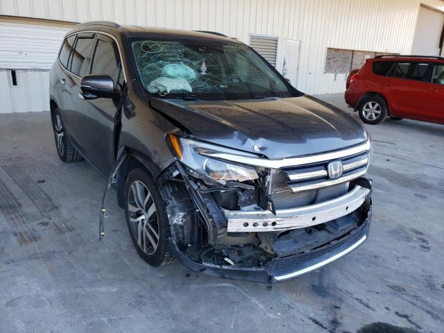 HONDA PILOT TOUR 2018 with VIN 5FNYF5H9XJB009261 - Photo from auction