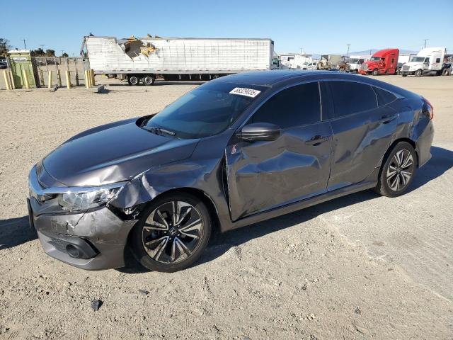 HONDA CIVIC EX 2018 with VIN JHMFC1F33JX040377 - Photo from auction