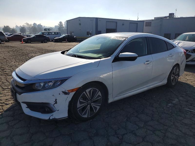 HONDA CIVIC EX 2018 with VIN JHMFC1F31JX002923 - Photo from auction