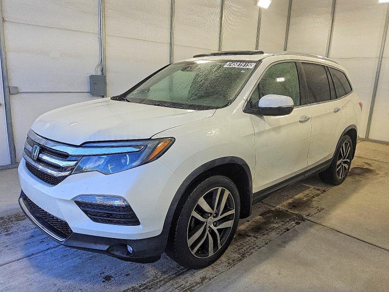 HONDA PILOT TOUR 2017 with VIN 5FNYF5H96HB039416 - Photo from auction
