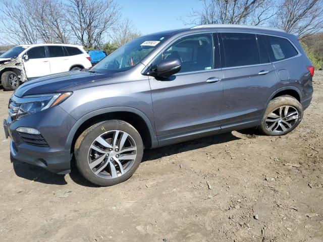 HONDA PILOT TOUR 2018 with VIN 5FNYF6H98JB008132 - Photo from auction