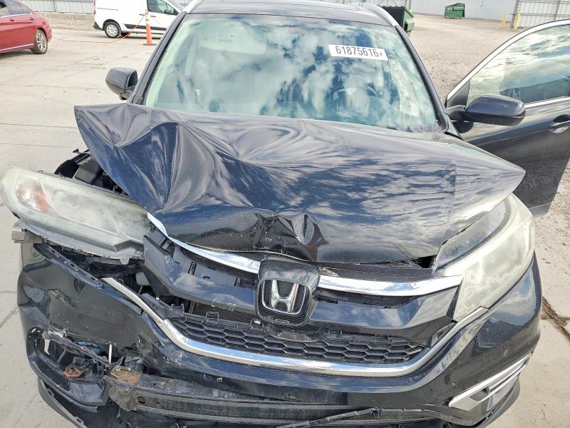 Photo 11 from auction – 2015 HONDA CR-V with VIN 2HKRM4H71FH659687