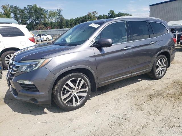 HONDA PILOT TOUR 2017 with VIN 5FNYF5H99HB006717 - Photo from auction