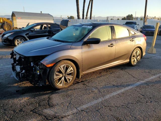 HONDA CIVIC EX 2018 with VIN JHMFC1F30JX037582 - Photo from auction