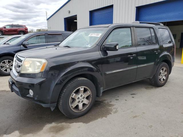 HONDA PILOT TOUR 2011 with VIN 5FNYF4H95BB070948 - Photo from auction