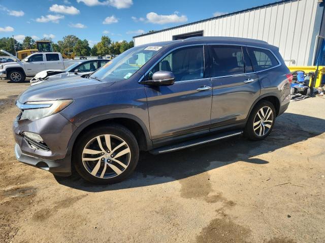 HONDA PILOT TOUR 2017 with VIN 5FNYF5H95HB016337 - Photo from auction