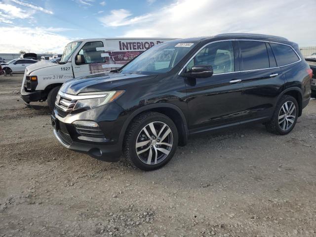 HONDA PILOT TOUR 2017 with VIN 5FNYF6H98HB096299 - Photo from auction