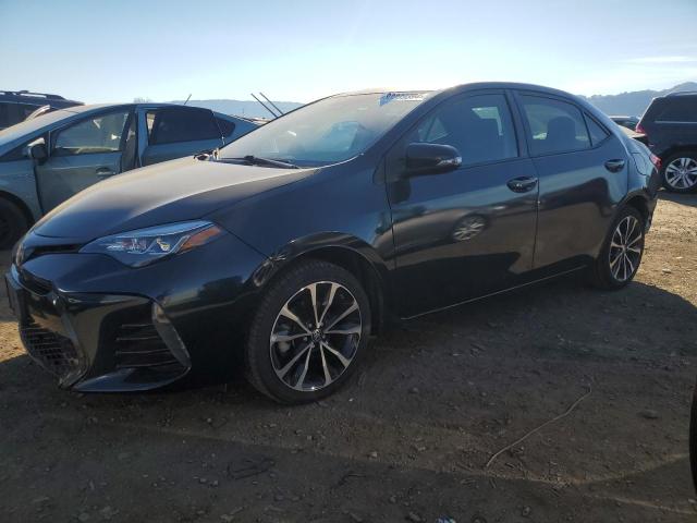 TOYOTA COROLLA L 2019 with VIN 5YFBURHE7KP875585 - Photo from auction