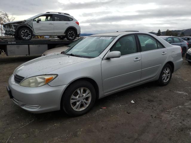 TOYOTA CAMRY LE 2004 with VIN 4T1BF30K24U570747 - Photo from auction