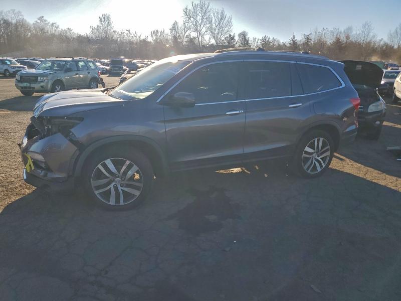 HONDA PILOT TOUR 2017 with VIN 5FNYF6H95HB027277 - Photo from auction