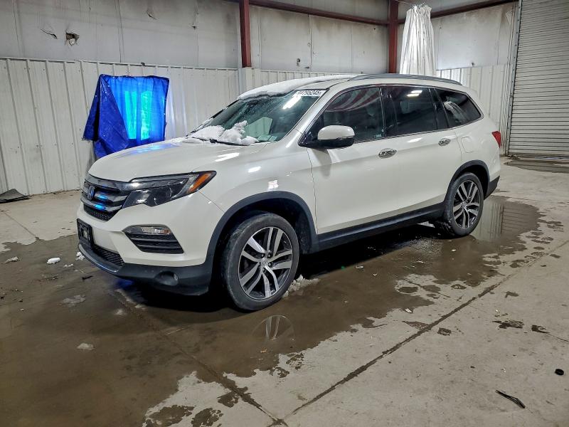 HONDA PILOT TOUR 2018 with VIN 5FNYF6H95JB058132 - Photo from auction